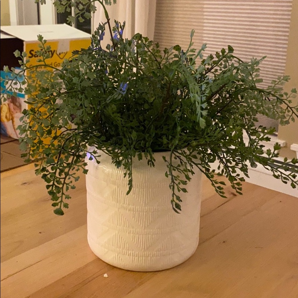 Vase with faux greenery.